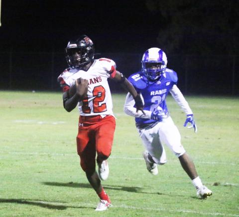Fort White receiver Najeeb Smith rushes up the field past Interlachen defensive back Jamarion Esau on Friday. (MORGAN MCMULLEN/Lake City Reporter)