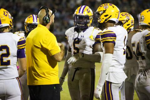 Columbia safety/linebacker Jaden Robinson (5) and cornerback Amare Ferrell (1) speak to co-defensive coordinator John Woodley during last Friday's game against Madison County. (BRENT KUYKENDALL/Lake City Reporter)