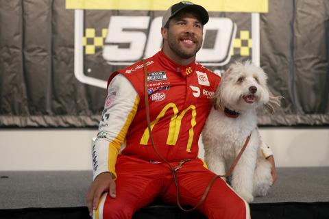 Bubba Wallace celebrates in victory lane with his dog Asher after winning the rain-shortened NASCAR Cup Series YellaWood 500 at Talladega Superspeedway on Monday in Talladega, Ala. (CHRIS GRAYTHEN/Getty Images/TNS)