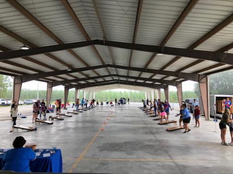 Participants in the fourth annual Suwannee Valley Cornhole Tournament play their matches on Saturday during the event. (COURTESY)