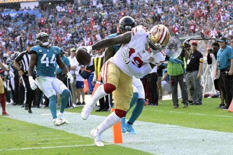 San Francisco 49ers wide receiver Deebo Samuel scores a 25-yard touchdown in front of Jacksonville Jaguars safety Rayshawn Jenkins, center, and linebacker Myles Jack (44) during Sunday’s game in Jacksonville. (PHELAN M. EBENHACK/Associated Press)