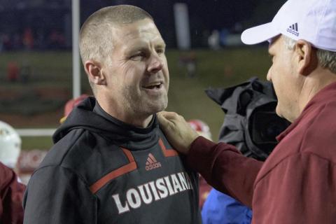 Louisiana-Lafayette head coach Billy Napier is congratulated by Louisiana-Monroe offensive coordinator Rich Rodriguez after Louisiana-Lafayette won 21-16 on Saturday in Lafayette, La. (MATTHEW  HINTON/Associated Press)