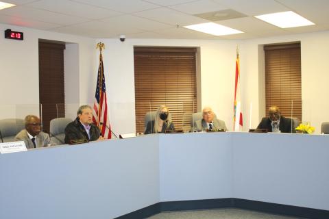 Council Members Eugene Jefferson (from left) and Todd Sampson, City Clerk Audrey Sikes, Mayor Stephen Witt and Council Member Jake Hill Jr. listen to a speaker at Monday’s city council meeting. (TONY BRITT/Lake City Reporter)