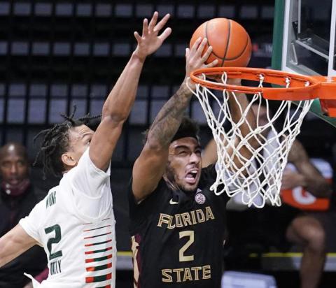 Florida State guard Anthony Polite drives to the basket as Miami guard Isaiah Wong defends on Feb. 24 in Coral Gables. (AP FILE)