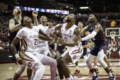 Florida State guard Cam'Ron Fletcher (21), guard Caleb Mills (4) and forward Malik Osborne (10) box out Pennsylvania for a rebound on Wednesday in Tallahassee. (MARK WALLHEISER/Associated Press)