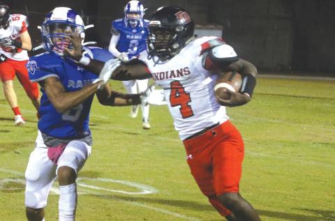 Fort White running back Maliki Clark stiff arms an Interlachen defender on Oct. 29. (MORGAN MCMULLEN/Lake City Reporter)