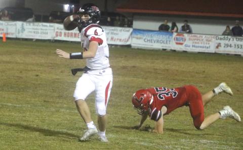 Fort White quarterback Clayton Philpot rolls out to pass against Lafayette during Friday’s Region 3-1A quarterfinal. (MORGAN MCMULLEN/Lake City Reporter)