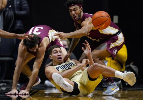 Purdue forward Mason Gillis (0) makes a pass from the floor in front of Florida State guard Anthony Polite (2) during Tuesday’s game in West Lafayette, Ind. (MICHAEL CONROY/Associated Press)