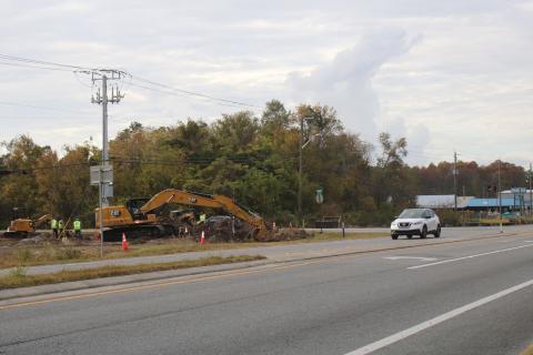 A construction crew works on digging ground for a new roundabout near Bascom Norris Drive. (TONY BRITT/Lake City Reporter)