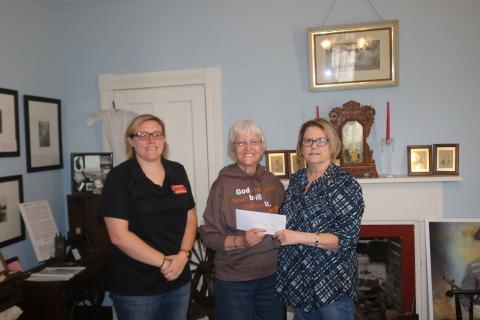 Rose Pavey (middle), the trustee from the Aloysius (Al) Harter trust, donates $25,000 to the Lake City-Columbia County Historical Museum. Accepting the donation for the museum are Kim Estergren (right), the museum president, and Shelly Fuller. (JAMIE WACHTER/Lake City Reporter)