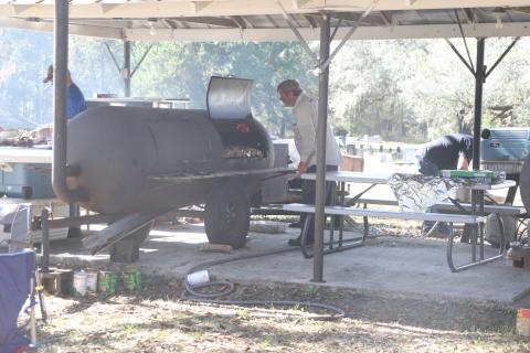 Pork is smoked at the Tustenuggee United Methodist Church on Wednesday, an annual pre-Thanksgiving tradition at the church for 63 years. (MORGAN MCMULLEN/Lake City Reporter)