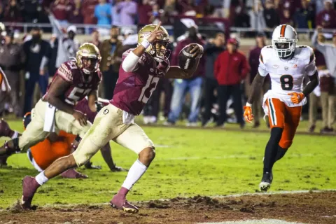 Florida State quarterback Jordan Travis scores a 2-point conversion with 25 seconds left against Miami on Saturday in Tallahassee. Florida State defeated Miami 31-28. (MARK WALLHEISER/Associated Press)