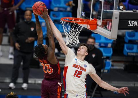 Florida forward Colin Castleton blocks the shot of Virginia Tech guard Tyrece Radford in the first round of the NCAA Tournament at Hinkle Fieldhouse on March 19 in Indianapolis. (AP FILE)