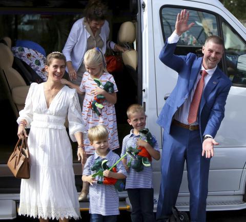 New Florida head coach Billy Napier shakes hands with fans as he and his family arrive at Ben Hill Griffin Stadium on Sunday in Gainesville. (BRAD MCCLENNY/The Gainesville Sun via AP)