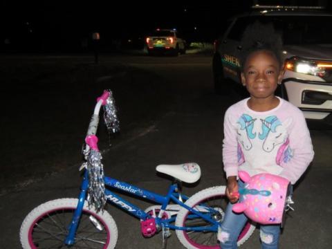 Jy’lar Fudge smiled Saturday night after receiving a new bicycle and a unicorn helmet from deputies with the Columbia County Sheriff’s Office. (COURTESY)