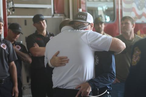 Lake City Fire Department Lt. Jeff McNeill hugs a fellow firefighter Wednesday afternoon at the Lake City Fire Station. McNeill was returning home from rehab in Jacksonville following a lengthy battle and recovery from covid-19. (JAMIE WACHTER/Lake City Reporter)