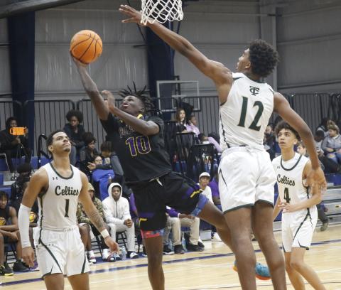 Columbia guard Isaac Broxey flies to the rim to score a basket against Trinity Catholic in the Hitchcock’s Challenge at Legacy Park on Wednesday in Alachua. (JORDAN KROEGER/Lake City Reporter)