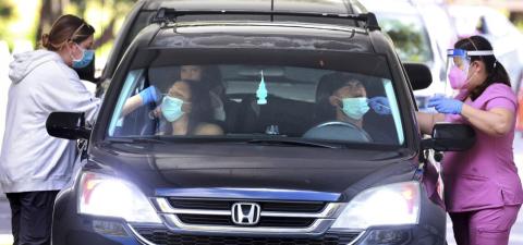 An Orange County family gets tested at the Econ Soccer Complex on the first day of the new covid-19 drive-thru testing site hosted by Orange County Health Services at the park off East Colonial Drive, in Orlando on Dec. 27. (JOE BURBANK/Associated Press)