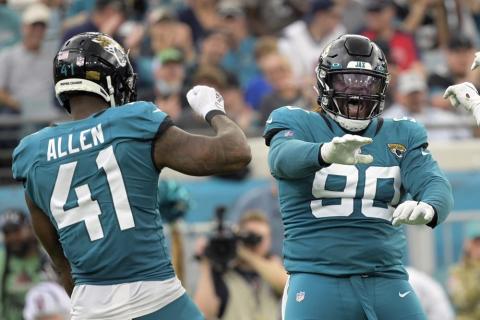 Jacksonville Jaguars defensive tackle Malcom Brown (90) and outside linebacker Josh Allen (41) celebrate a play against the Houston Texans on Dec. 19 in Jacksonville. (PHELAN M. EBENHACK/Associated Press)