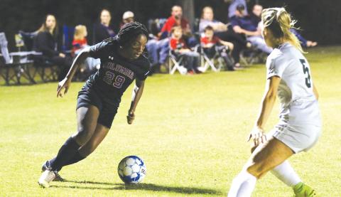 Columbia’s Olivia Kelly takes on Suwannee’s Hannah Humphries inside the penalty box during Friday night’s match. (MORGAN MCMULLEN/Lake City Reporter)