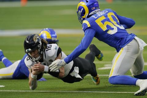 Jacksonville Jaguars quarterback Trevor Lawrence lunges for yardage against the Los Angeles Rams on Dec. 5 in Inglewood, Calif. (MARK J. TERRILL/Associated Press)