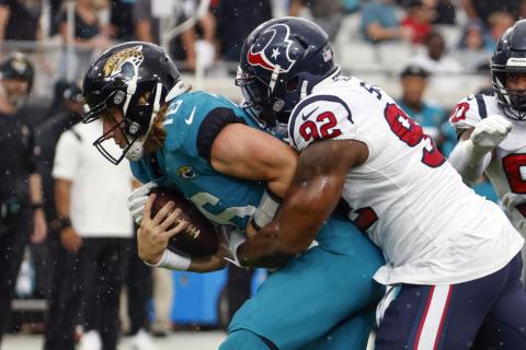 Houston Texans linebacker Chris Smith (92) sacks Jacksonville Jaguars quarterback Trevor Lawrence, left, during Sunday's game in Jacksonville. (STEPHEN B. MORTON/Associated Press)