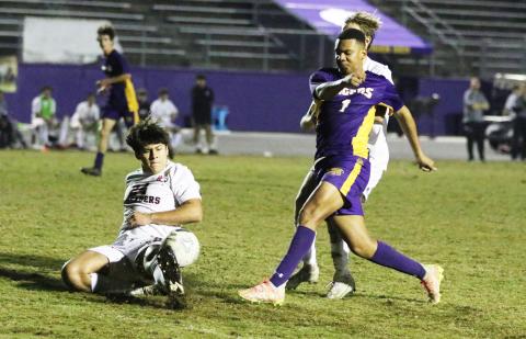 Columbia’s AJ Brinson fires a shot inside the penalty box as Bishop Kenny defenders rush in during Thursday’s match. (MORGAN MCMULLEN/Lake City Reporter)