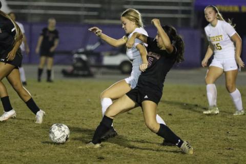 Columbia’s Carla Medina fights for possession of the ball with Forest’s Rylynn Robinson on Friday. (MORGAN MCMULLEN/Lake City Reporter)