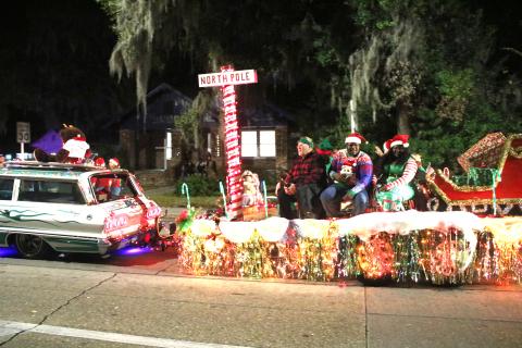 A parade float featuring Santa’s sleigh and a North Pole marker makes its way down Marion Avenue during the 2019 Christmas parade in Lake City. (FILE)