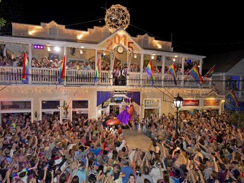 “Sushi,” portrayed by Gary Marion, is lowered to the ground in a giant facsimile of a woman’s red high heel on Duval Street on Jan. 1, 2015, at the Bourbon Street Pub in Key West. (BOB O'NEAL/Associated Press)