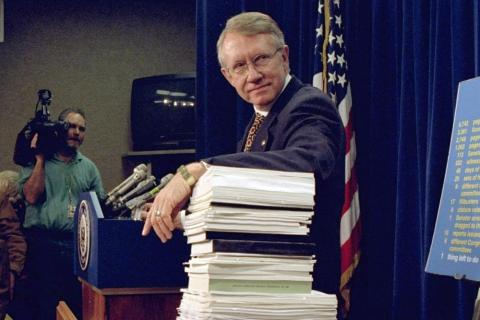 Sen. Harry Reid, D-Nev., leans on a stack of documents pertaining to campaign finance reform during a Capitol Hill news conference on Dec. 3, 1996, where the Democratic leadership for the 105th Congress was announced. (DENNIS COOK/Associated Press)