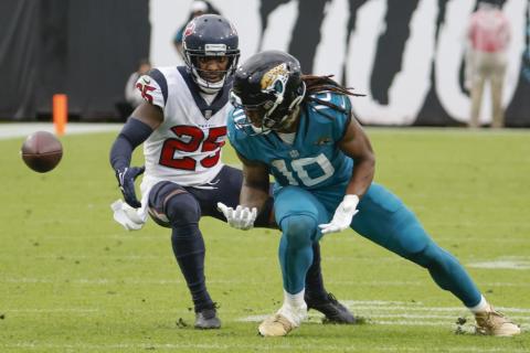 A pass slips through the hands of Jacksonville Jaguars wide receiver Laviska Shenault Jr. as he is defended by Houston Texans cornerback Desmond King during Sunday's game in Jacksonville. (STEPHEN B. MORTON/Associated Press)