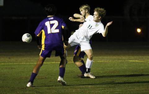 Columbia’s Jakob North (middle) and Lincoln’s Kyle Spratt fight for possession of the ball as Columbia’s Eduardo Morales rushes in during Monday night’s match. (JORDAN KROEGER/Lake City Reporter)