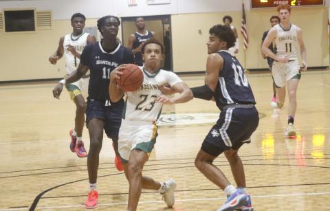 FGC guard Jazan Johnson drives past Santa Fe College guard Nicolas McClain on Tuesday night at the Howard Center. (JORDAN KROEGER/Lake City Reporter)