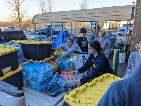 CHS FFA Alumni president Kelly Trimble (center) helps unload supplies with FFA members in Kentucky. (COURTESY)