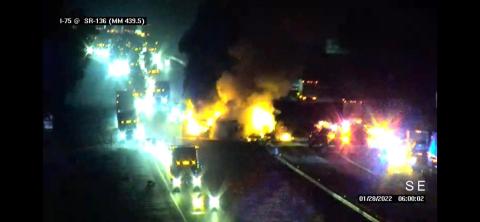 Footage from a camera overlooking I-75 shows a semi truck on the right ablaze as traffic stalled behind it. (COURTESY)