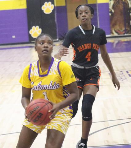 Columbia guard Anzarria Jerkins goes up for a shot as Orange Park guard Eris Lester chases from behind on Thursday night. (JORDAN KROEGER/Lake City Reporter)