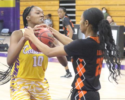 Columbia center Keturah Taylor fights for possession of the ball with Orange Park forward Nia Brown on Jan. 13. (JORDAN KROEGER/Lake City Reporter)