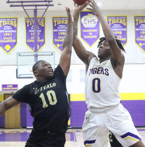 Columbia forward Marcus Peterson shoots over The Villages forward Ja-Quez Oliver on Friday night. (JORDAN KROEGER/Lake City Reporter)