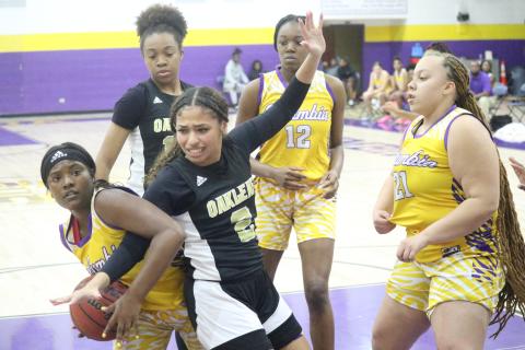 Columbia guard Anzarria Jerkins is defended by Oakleaf guard Khyree Malone-Day on a drive to the basket on Wednesday night. (JORDAN KROEGER/Lake City Reporter)