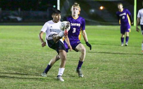 Suwannee's Luis Lopez performs a bicycle kick as Columbia's Riley Stone defends on Jan. 7. (BRENT KUYKENDALL/Lake City Reporter)