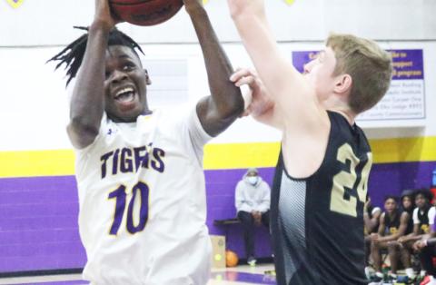 Columbia guard Isaac Broxey rises to shoot as The Villages Charter forward Sam Walters contests on Friday night. (JORDAN KROEGER/Lake City Reporter)