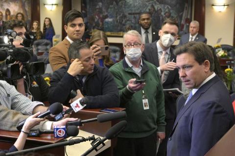 Florida Gov. Ron DeSantis, right, answers questions from reporters after addressing a joint session of a legislative session, Tuesday, Jan. 11, 2022, in Tallahassee, Fla. (PHELAN M. EBENHACK/Associated Press)