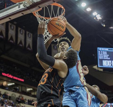 Miami guard Kameron McGusty (23) is blocked by Florida State guard Anthony Polite (2) during Tuesday's game at the Tucker Civic Center in Tallahassee. (ALICIA DEVINE/Tallahassee Democrat via AP)