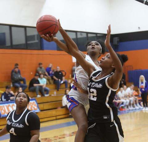 Fort White forward Isreal Hart (12) blocks a layup attempt from Branford’s Zjamyah Wilson during Thursday night’s 56-26 Indians win at LeNelle Phillips Morgan Gym. (PAUL BUCHANON/Special to the Reporter)