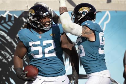 Jacksonville Jaguars defensive tackle DaVon Hamilton (52) celebrates after recovering an Indianapolis Colts fumble with teammate defensive end Adam Gotsis during Sunday's game in Jacksonville. (PHELAN M. EBENHACK/Associated Press)
