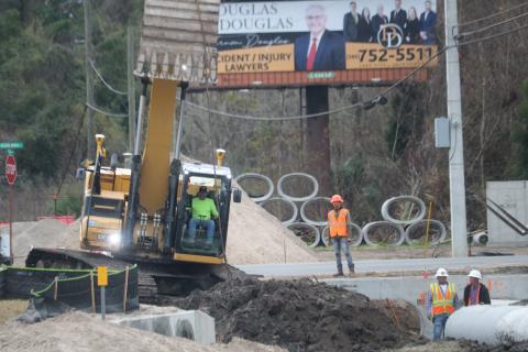 A construction crew works on the drainage system near the future roundabout at Northwest Bascom Norris Drive and U.S. Highway 41. (TONY BRITT/Lake City Reporter)