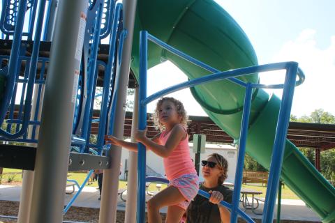 Sailor Hunter (left) plays on the jungle gym playset erected at Columbia City Park in July 2020. (FILE)
