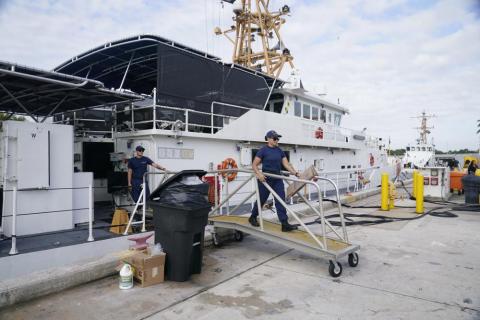 Crew members of the Coast Guard cutter William Flores get ready to go on patrol in Miami Beach. About 40 people left the island of Bimini in the Bahamas on Saturday evening in what the maritime security agency suspects was a human smuggling operation. (MARTA LAVANDIER/Associated Press)