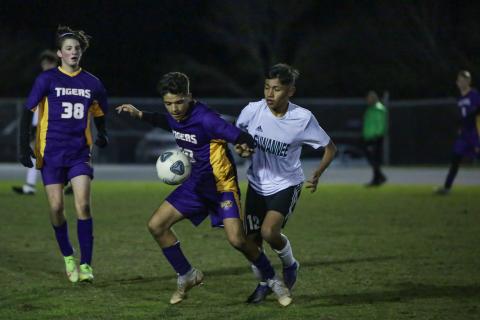 Columbia junior Jason Caballero (left) shields the ball away from Suwannee midfielder Joel De La Cruz during Friday night’s game at Columbia High School. (BRENT KUYKENDALL/Lake City Reporter)
